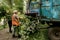 The work of a mobile shredder of dry branches and trees in a city park. Wood shredder. Workers recycle broken trees