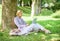 Work outdoors benefits. Woman with laptop computer work outdoors lean on tree trunk. Education technology and internet