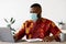 Work During Pandemic. Black Freelancer Guy In Mask Using Laptop At Home