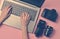 The work of the photographer, photo retouching. Photographic equipment, female hands typing on laptop keyboard on pink pastel