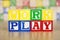 Work Play Spelled Out in Alphabet Building Blocks