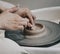 Work in a pottery workshop. close-up of hands and potter`s wheel