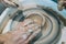 Work in a pottery workshop. close-up of hands and potter`s wheel