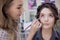 The work of a professional makeup artist. Stylist makeup artist doing makeup and hair in a beauty salon.