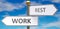 Work and rest as different choices in life - pictured as words Work, rest on road signs pointing at opposite ways to show that