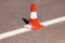 Work on road. Construction cone. Traffic cone, with white and orange stripes on asphalt. Street and traffic signs for signaling.