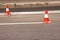 Work on road. Construction cones. Traffic cone, with white and orange stripes on asphalt. Street and traffic signs for signaling.