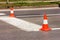 Work on road. Construction cones. Traffic cone, with white and orange stripes on asphalt. Street and traffic signs for signaling.