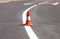 Work on road. Construction cones. Traffic cone, with white and orange stripes on asphalt. Street and traffic signs for signaling.