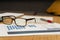 Work table at home with pen, papers, bills, charts, glasses, computer and calculator. Concept work at home, checking accounts,