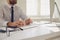 Work training online. Male hands of businessman tipping using keyboard on computer desk.