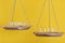 Work vs life. Balance concept. Scales on yellow background, close up