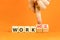 Work or workaholic symbol. Concept words Work or Workaholic on wooden cubes. Beautiful orange table orange background. Businessman