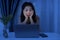 Workaholic business Asian woman working late at night feeling sleepy and tired sitting at desk with laptop