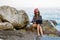 Workaholic young woman in a Santa hat working on the beach