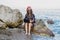 Workaholic young woman in a Santa hat working on the beach