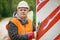 Worker with adjustable wrench on the bridge repairing road sign