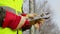 Worker with adjustable wrench at outdoors near fence