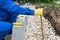 Worker aligns curbstone with yellow rope