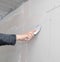 Worker aligns the walls with plaster. Repair in the house