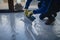 The worker applies gray epoxy resin to the new floor