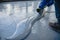 The worker applies gray epoxy resin to the new floor