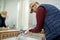 Worker applying silicone sealant in the bathroom.