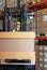 Worker in auto parts warehouse use a forklift to work to bring the box of auto parts into the storage shelf