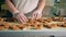 Worker at bakery production at food factory operating cookies conveyor. 4K.