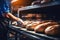 A worker in a bakery puts bread in the oven. Bread production enterprise. Bakery. Close-up