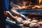 A worker in a bakery puts bread in the oven. Bread production enterprise. Bakery. Close-up