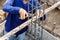 Worker bending steel rod for construction job