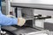 Worker bends a metal plate on the industrial machine