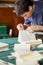 Worker Binding Book At Table In Paper Factory