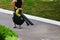 Worker blows dust off the asphalt