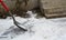 Worker breaking, cleaning the ice with a shovel