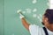 Worker builder plasterer plastering a wall of drywall at a construction site indoors