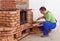 Worker building masonry heater