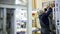 A worker builds electrical equipment, power transformer on a factory.