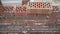 Worker builds a wall of colored brick. Worker in Close up of industrial bricklayer installing bricks and mortar cement brick on