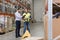 Worker and businessmen with clipboard at warehouse