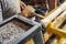 Worker carpenter processes a wood on a lathe