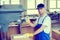 Worker in a carpenter\'s workshop using drilling machine