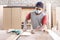 Worker at carpenter workspace cutting the wood board using saw t