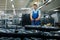 Worker carries bicycle wheels on a cart, factory