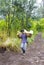 Worker carries sulfur from crater