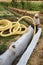 A worker carries a yellow perforated drainage pipe. Groundwater drainage works in the field