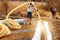 A worker carries a yellow perforated drainage pipe. Groundwater drainage works in the field