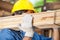 Worker Carrying Tied Wooden Planks At Construction