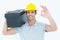 Worker carrying tool box on shoulder while gesturing OK sign